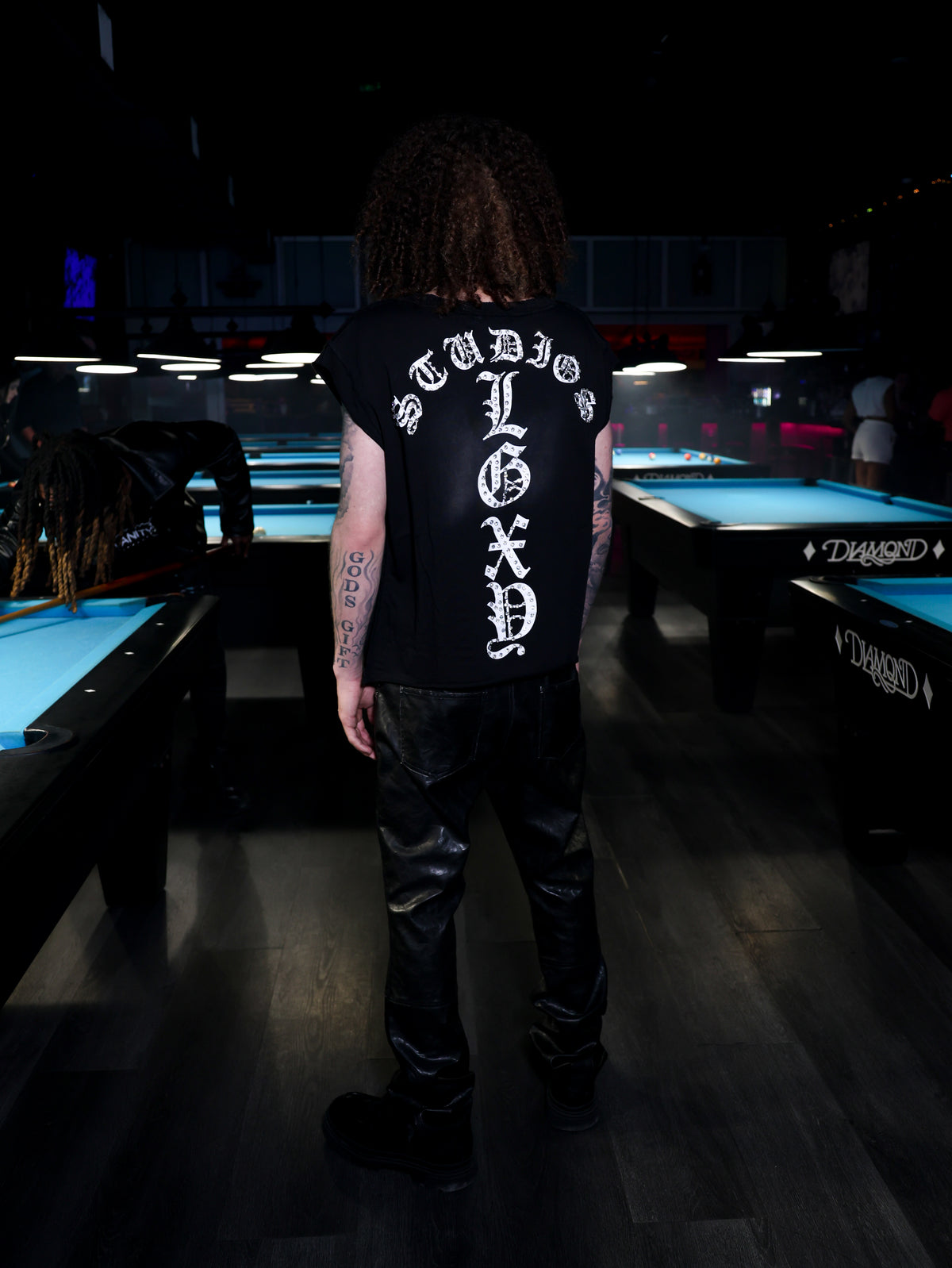 Black Mötely Crüe T-shirt by Legaxy Studios featuring band-inspired graphic print on soft cotton fabric.