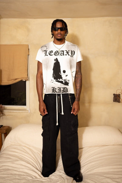 Front view of a children's LEGAXY KID T-shirt by Legaxy Studios, featuring a colorful space-themed design on soft cotton fabric.