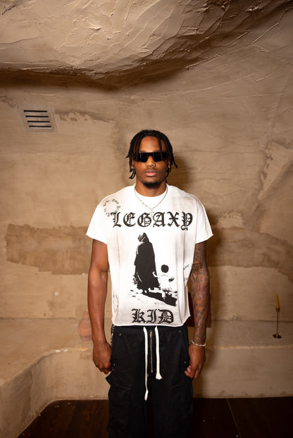 Front view of a white Legaxy Kid T-shirt by Legaxy Studios, featuring a colorful graphic design for children.